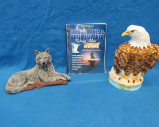 Lot 334. Eagle cookie jar, wolf figurine, and a fishing map book.