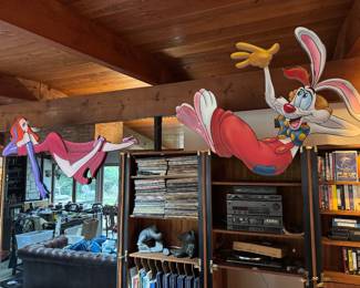 This is Jessica & Roger Rabbit Promotional "hard board painted - cut outs" as they would have hung off of a ledge in Walt Disney World for the First Viewing of the Movie. We hung them off of the top of the wall unit in the home, Jessica is hanging over a mirror and we took off the doors of the Electronic Area