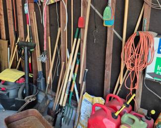 Yard equipment. Red wagon. Gas cans. 