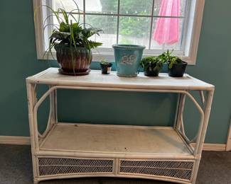 Wicker table. Currently used as plant stand so could use a good cleaning (unless using for plants). Other than that, in good condition. L- 44in, W-18in, H-29in. Available for presale. Text 407-448-3093.