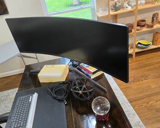 large, curved monitor and other office accessories