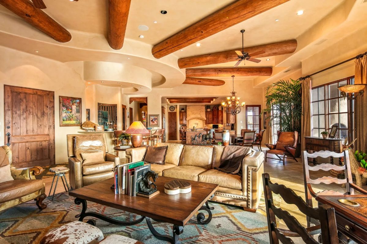 Hancock and Moore recliner, cowhide chair, large area rug, hancock and moore sofa, ladlows coffee table, petrified wood end table