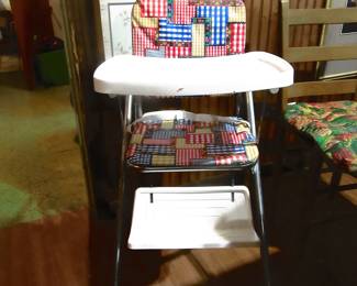 Vintage baby highchair, located in kitchen area.