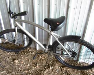 One of two bicycles, them are in need of air in tires, located in barn,