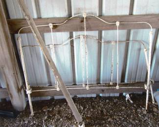 Early vintage iron bed with rails. Located in barn.