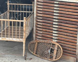 Antique crib, snowshoes and Hamilton typesetter cabinet. 