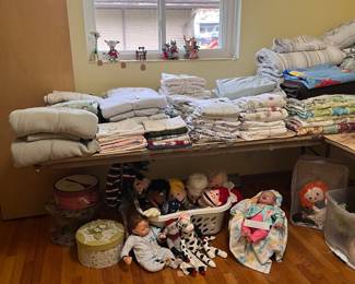 Linens, puppets and real life baby with clothes. 