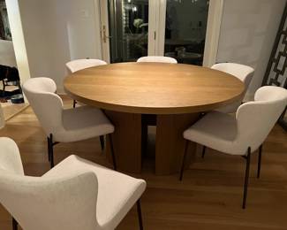 Anthropologie round dining table purchased in 2024 from outlet store for $900. Has a flaw on the table top where a screw from the base pushed through. This has been repaired but color needs to be restored with a wood pen.
