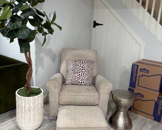 Bob's store small swivel chair with ottoman. Very comfortable, very good condition. Faux tree with planter and silver side table are also for sale.