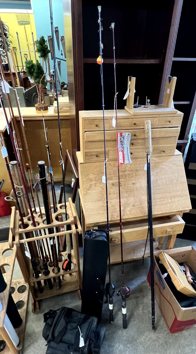 A room full of fishing equipment and supplies, custom work stand for making  lures, etc
