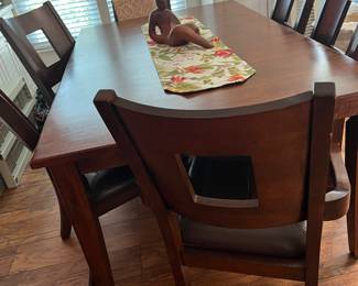 Beautiful dining room table...six leather seated chairs..excellent condition (Klaussner Home Furnishings)