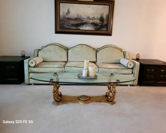 Vintage French Provincial Style Sofa/2 Vintage dark wood square end tables with built-in storage and carved paneling/Vintage Weiman Victorian Gold Leaf Glass Coffee Table/Vintage Joseph Fruhmesser original oil painting on canvas depicting woodland lake scene with mountains