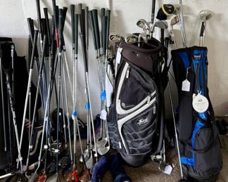Lots of Golf Clubs and Bags