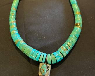 Royston turquoise heishi beads with claw pendant. Unsigned.