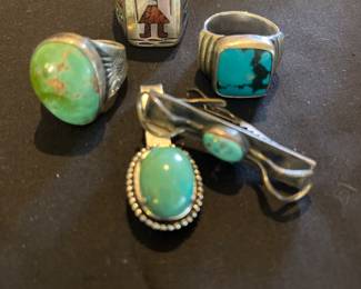 From left is Old Pawn ring, Inlay ring signed J W Tom. Bisbee turquoise rings signed Bisbee Bob. Turquoise tie clip and turquoise money clip.