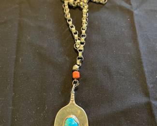 Flattened sterling spoon with Blue Gem turquoise on bench made necklace.