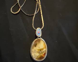 Unusual opal butterscotch amber pendant . Signed. AV
