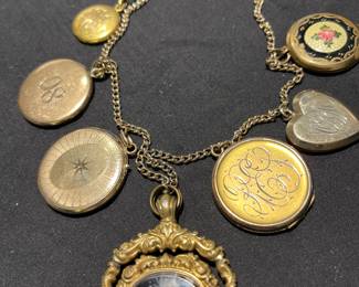 Necklace of gold filled lockets . Center has striped agate Masonic fob.