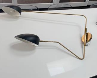 Two wall sconces one is with black lights and one is with white asking 150 for each the arms move
