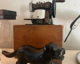 Children’s Busy Bee Sewing machine in perfect condition with original box. Antique black lab dog nut cracker also in great condition. Crystal antique door knob.