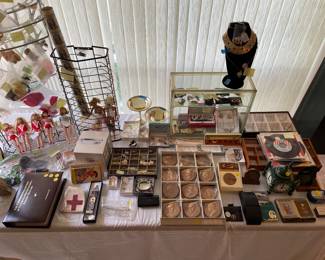 Better jewelry table. Vintage presidential medallions. 1st Gen. iPod in orig. box. Uncut dollar sheet. Vintage Barbie’s and accessories.