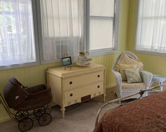 Antique yellow dress. Antique stroller. White wicker chair.