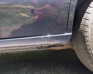 Rust area below sliding door (driver's side)