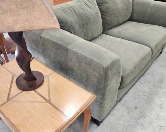 Settee,  inlaid coffee table,  and wood lamp