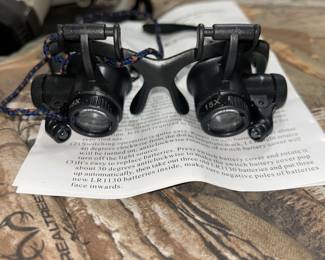 pair of binocular magnifying glasses with LED illumination, also known as jeweler's loupes or watch repair magnifiers. 