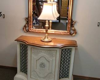 Vintage Gilt/Gold Baroque/Rococo style large beveled mirror. Vintage Magnavox Console with 2/4 channel sound,and built-in/hidden turntable record player, 8-track player, and receiver/amplifier and built-in speakers.