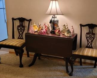 2 Solid Wood Carved Chippendale Dining Chairs. Vintage Solid Wood Double Drop Leaf Table (40"x19" with leaves down. 40"x 78" with leaves up). 10 Assorted Royal Dalton Figurines. 1 Franklin Porcelain Figurine. Blue/White/Gold Chinoiserie Ginger Jar porcelain lamp.