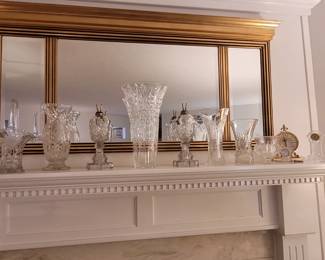 Gilded/Gold framed, 3 panel, beveled mirror above mantel, approx 55"x 27". 2 vintage whale oil glass lamps. Assorted crystal vases. Assorted table clocks, including 3 Waterford Crystal cloks, and an ImHof Buchere Gilt solid metal case swiss quartz clock ref# 71-861 (with original Sep 1976 purchase documentation).