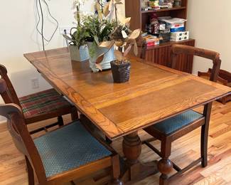 Solid Wooden Table with 4 chairs; the 2 outer sections of the table slide under
