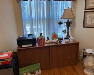 Pair of wooden filing cabinets, office supplies, and random decor