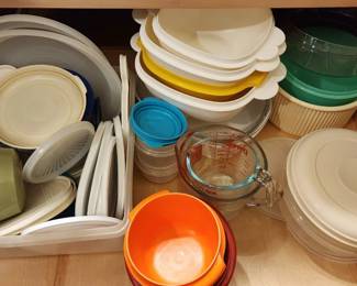 Kitchen has many drawers full of mixing bowls, plastic and glass.