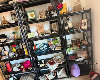 On these wood shelves houses a lot of various items, scales, rocks, hats, candles, statues, mirrors, books, jewelry and more..