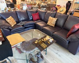 An L shaped Leather Factory Plum couch...lots of colored pillows to choose from, and a large glass and metal coffee table