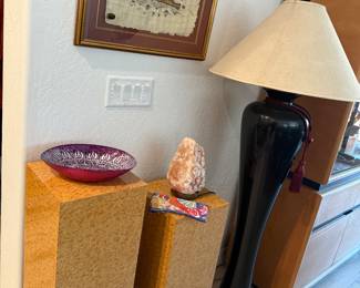 Stands for plants or special statues, a tall black lamp and artwork from Egypt