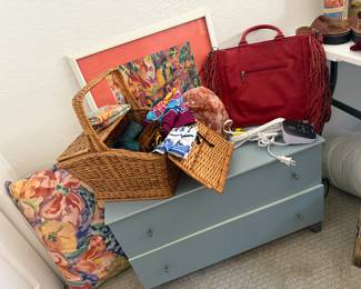 some great bird artwork, small cabinet and a great red purse...