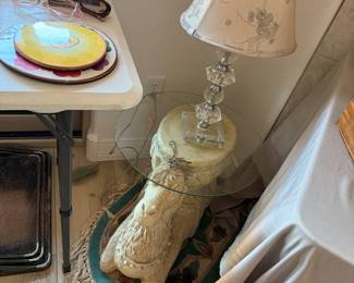 A camel supports this glass top small end table, and a cute lamp