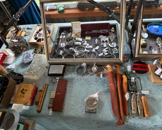 Family Room- Case Table
Sterling jewelry 
Jack knives 
*There is sooo much more costume jewelry not pictured because we are still marking it all. A 4’ table full! 