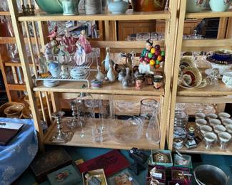 Family Room - Case Table 
Royal Doulton figurines, sterling silver candlesticks, cloisonné ornaments, etched glass pieces, Hull pottery, Roseville pottery, Rookwood pottery, Orivfers glass cat decanter 
