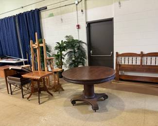 Full size bed frame with side rails, antique table, victorian table, Stack of Novels wood library side table, Kenmore cabinet sewing machine, tall faux plants, oak plant stands, easel, wood stools