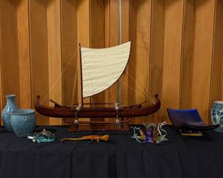 Handmade Hawaiian canoe outrigger, blown glass octopus with gold metallic finish, bronze gecko (Frogman, Feugo), blown glass octopus by Michael Hopko, rectangular glass dish, pottery Hawaiian vases