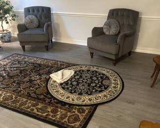 Upholstered armchairs and area rugs