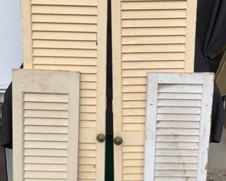 Double wooden louvre doors and pair of exterior wooden shutters.