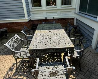 Suite of cast iron outdoor furniture table and 6 chairs $1,800