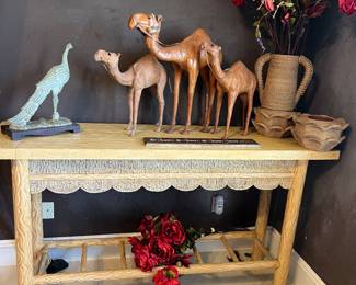 One of two carved wood sofa tables, silk flowers, leather camels