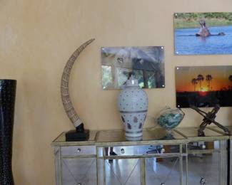 Pair of mirrored cabinets, bric-a-brac, framed African animal photographs