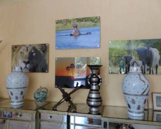 Pair of mirrored cabinets, bric-a-brac, framed African animal photographs